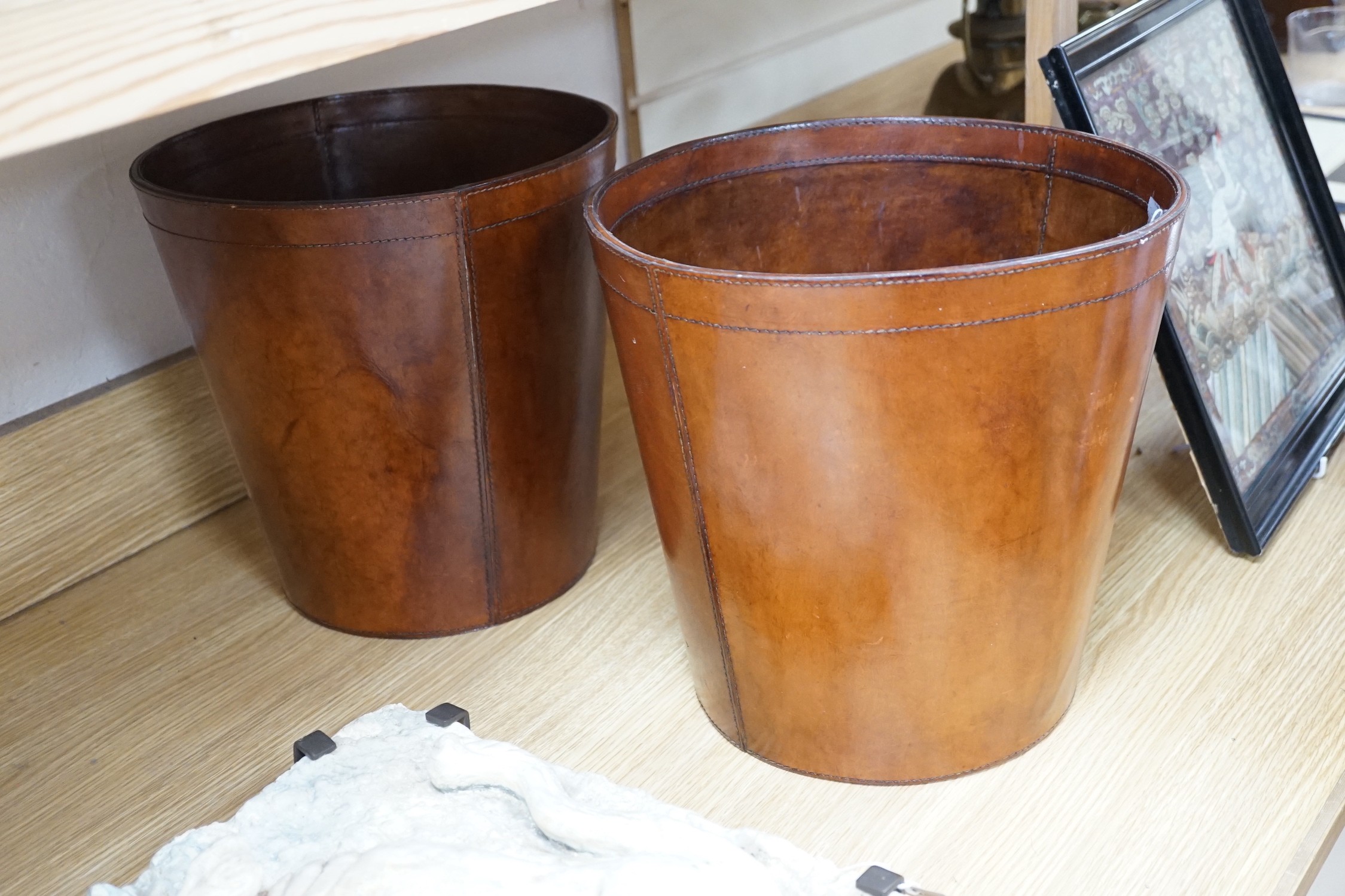 Two brown leather waste paper bins, 30cms high